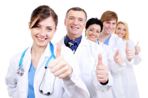 group of happy laughing doctors with gesture thumbs-up standing in line